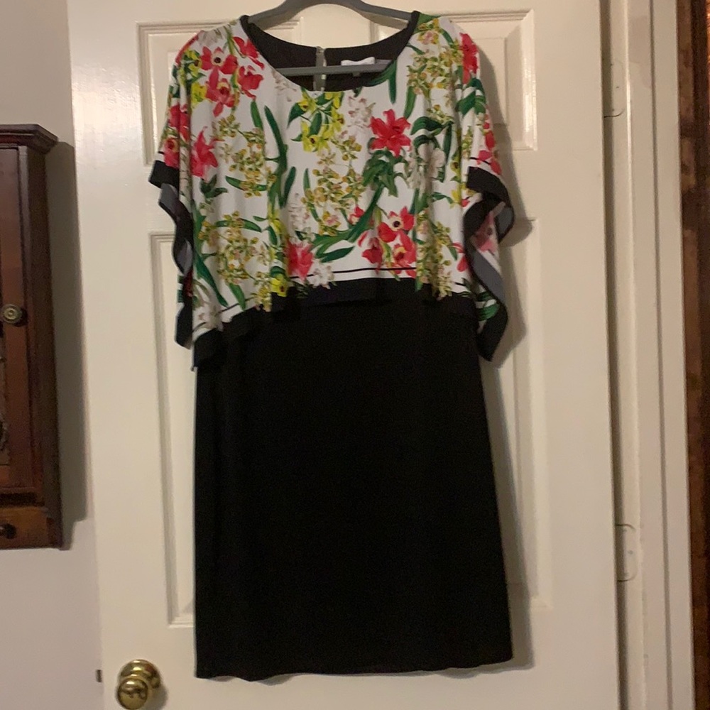 Beautiful black dress with attached floral flap.